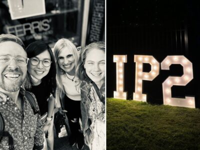 Group photo of attendees and the IP2 signage